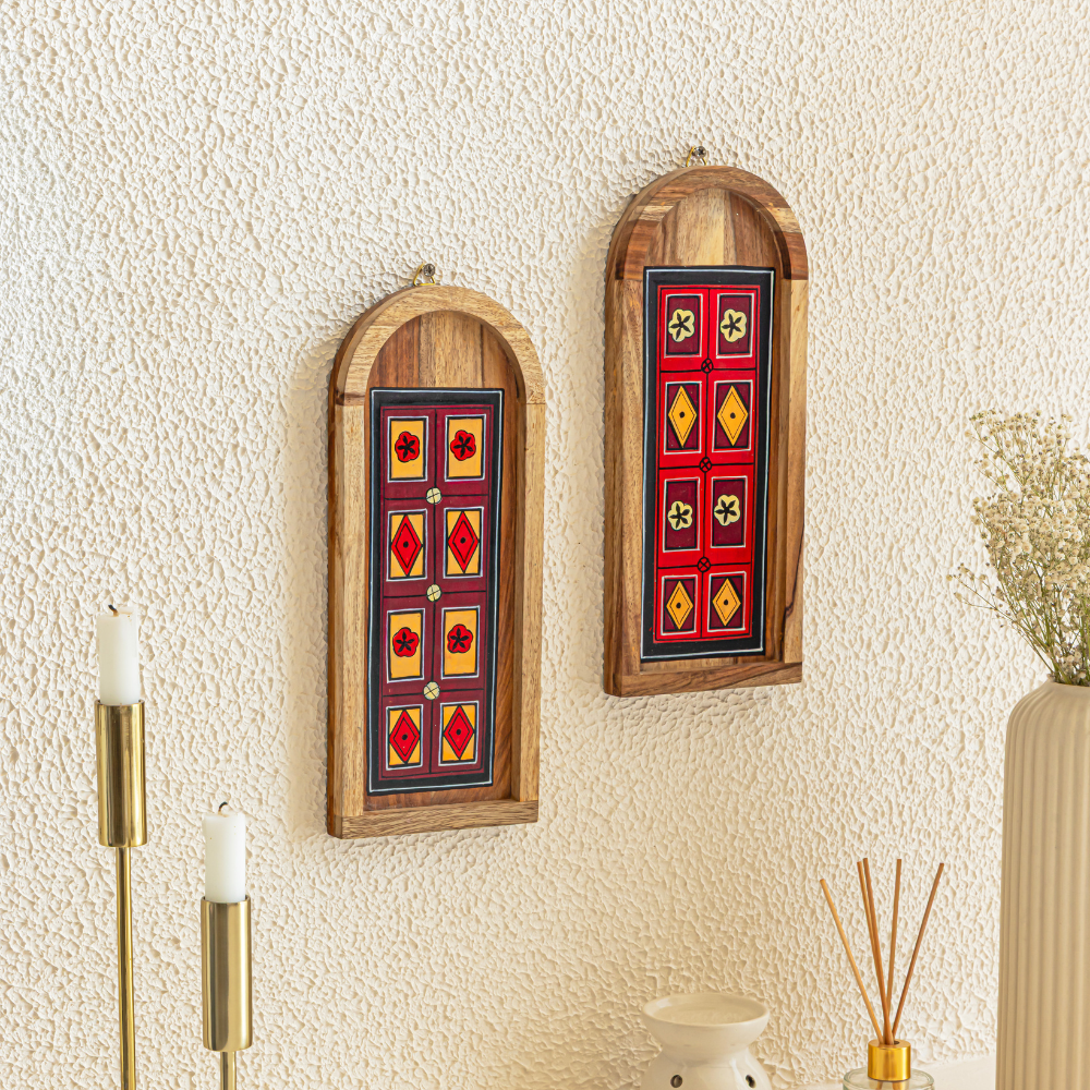 Pair of Dwar wooden wall plates by Mirai Woods, traditional entryway decor with intricate carved designs on natural wood surfaces.